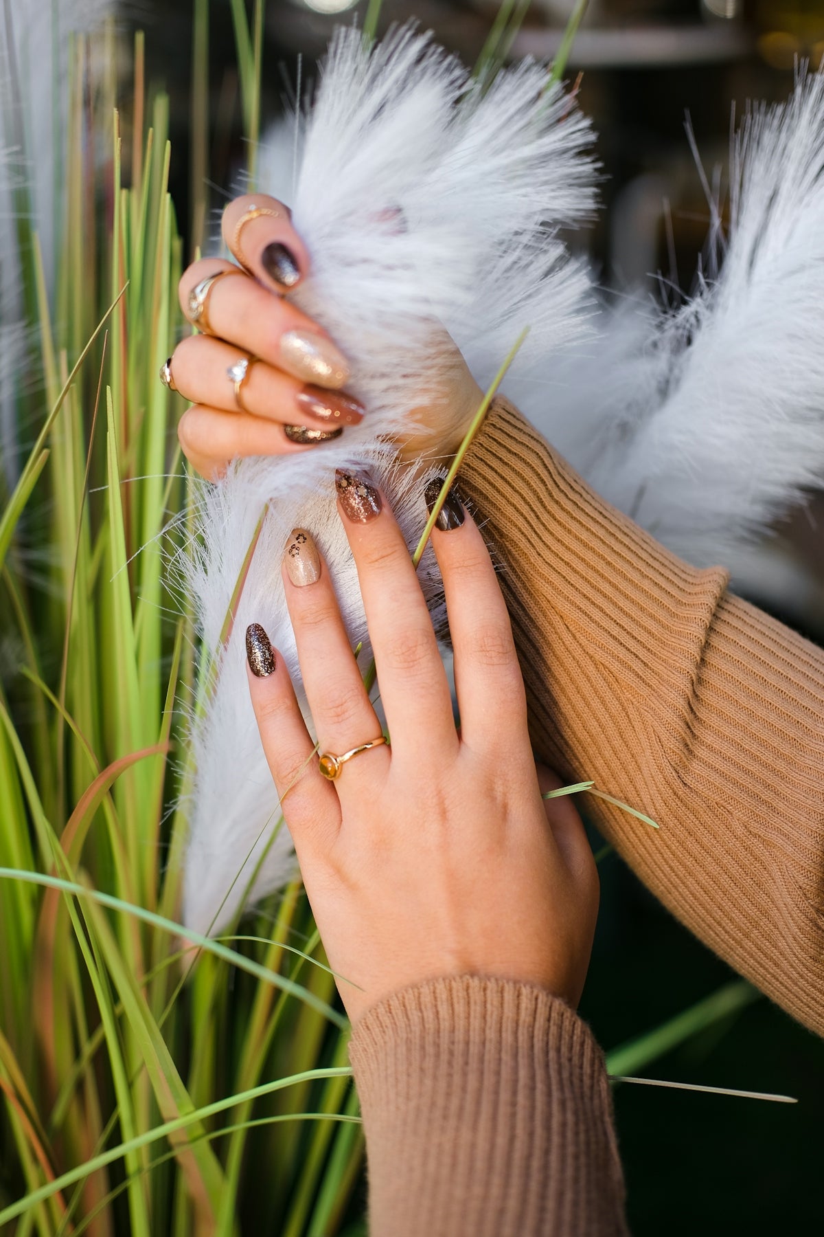 a woman is holding a feather in her hand